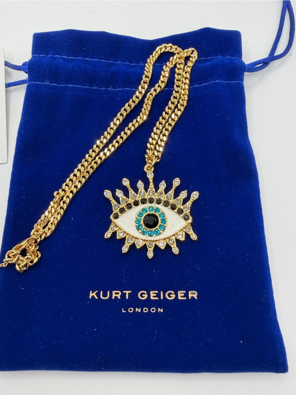 Kurt Geiger Gold Eye Pendant Necklace with Teal and Black Accents